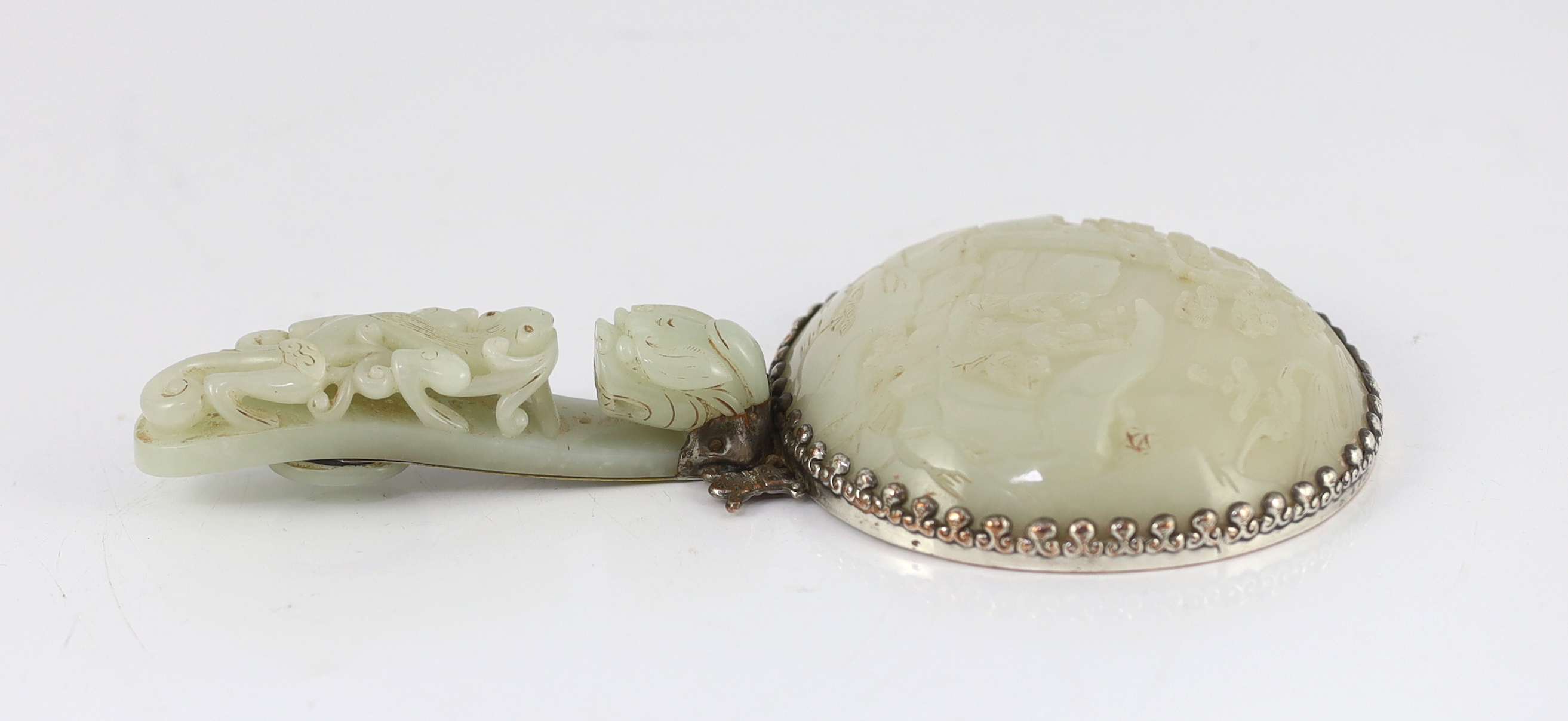 An early 20th century Chinese plated hand mirror with 18th/19th century jade mounts